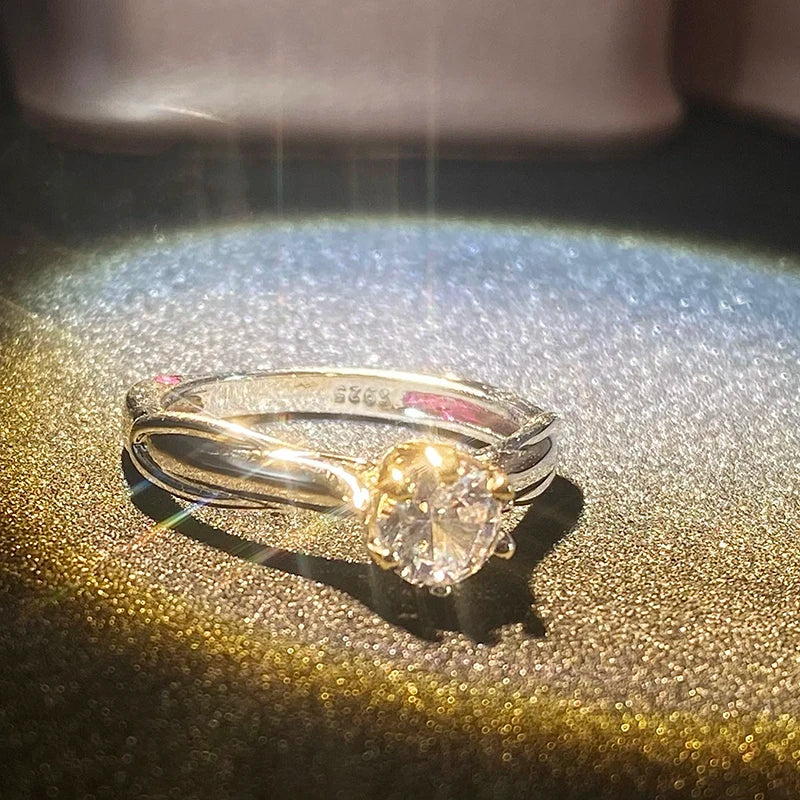 Gold ring with a large diamond on a reflective surface