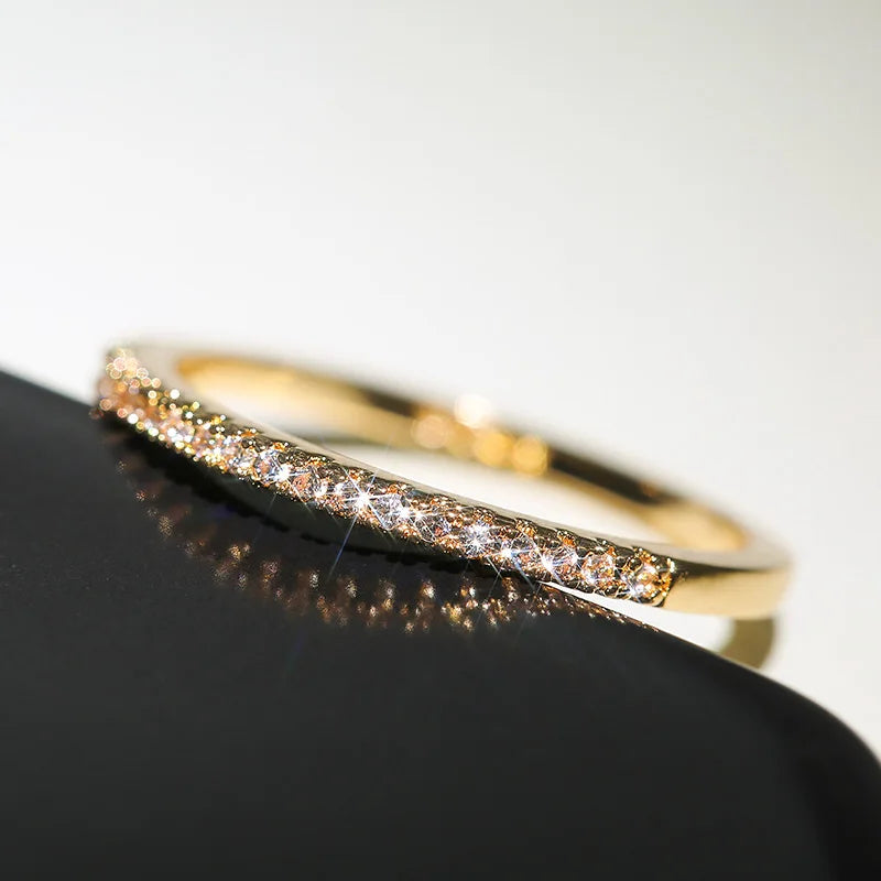 Gold bracelet with embedded diamonds on a black surface
